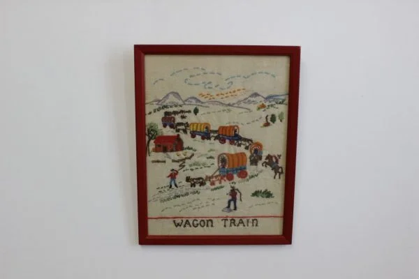 Vintage needlepoint titled Wagon Train |